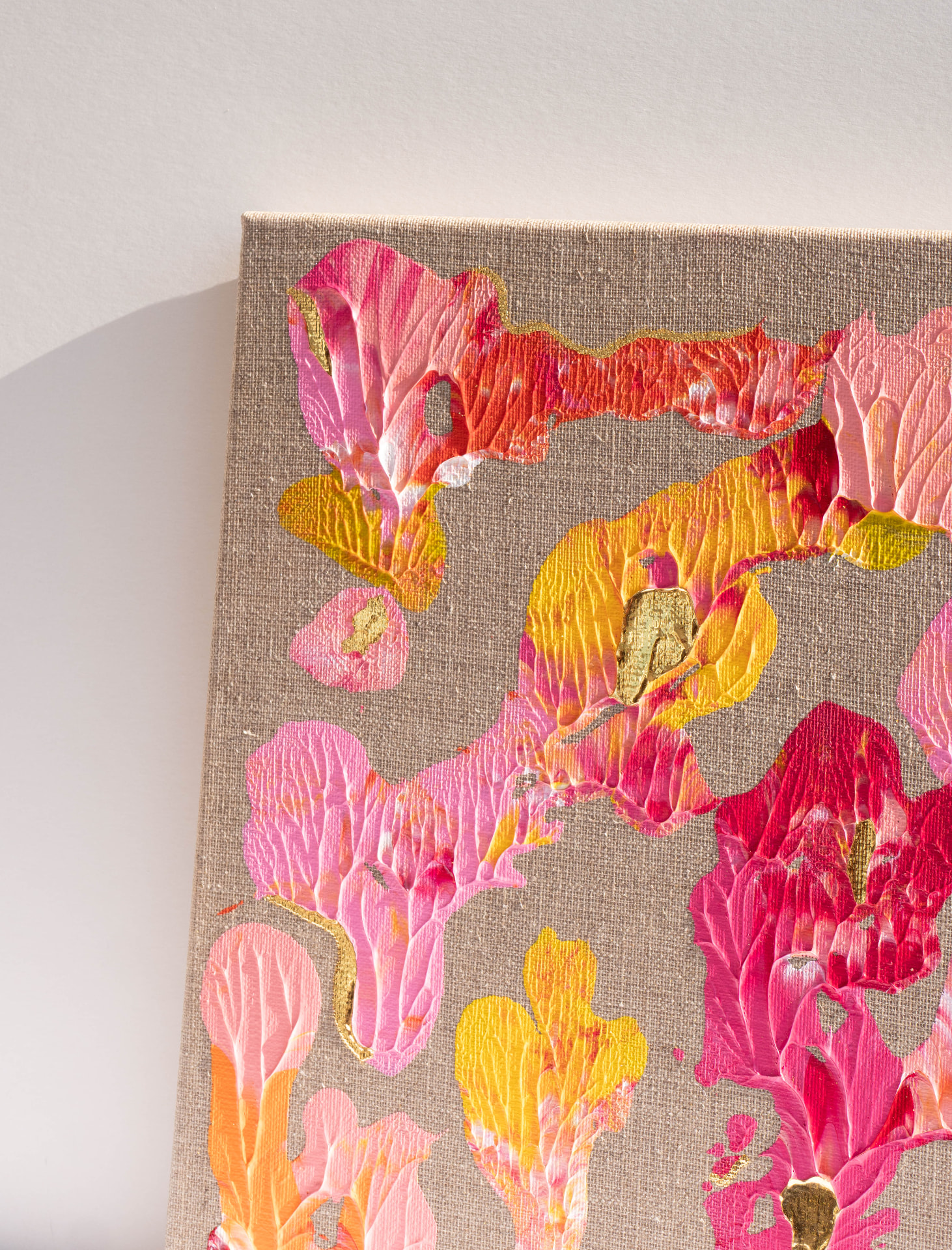 Detail der Technik Foliogenese: blütenartige Formen in Pink und Gold auf Leinen